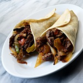 Mexican fajitas with beef, peppers and onions
