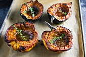 Roasted pumpkins with thyme on a baking sheet