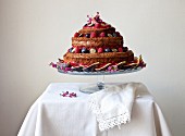 A naked birthday cake with fresh figs and berries
