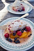 Peach, raspberry and blueberry cobbler on plates