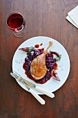 Roast leg of goose on a bed of red cabbage