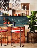 Art-Deco bar stools at kitchen counter and large house plant in basket