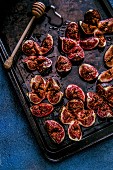 Roasted figs with honey on a baking sheet