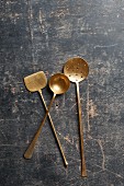 A copper turner, ladle and strainer spoon