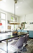 Lilac, retro upholstered chairs around dining table in vintage kitchen
