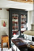 Crockery in glass-fronted cabinet in vintage interior