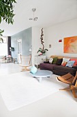 Colourful retro furniture in bright living room with white floor