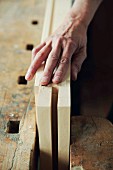 Wood being sanded with sanding paper