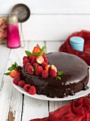 Vegan chocolate cake with raspberries and strawberries