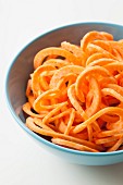 Raw sweet potato spirals in a bowl