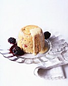 A steamed pudding with blackberries