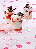 An ice cream sundae with cherries and chocolate biscuits