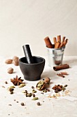 Masala chai spices with a pestle and mortar