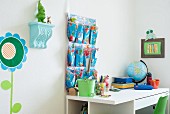 Desk and wall organiser in child's bedroom with blue and green accents