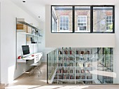 Bright workspace on gallery with modern glass balustrade