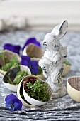 Cress in egg shells lined with newspaper