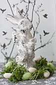 Easter bunny in nest of cress and sugar eggs
