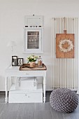 Boxes below desk below small glass-fronted cabinet on wall