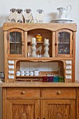 Ornaments on traditional dresser with glass-fronted top