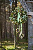 Wreath of oak leaves and ribbons hung in woods
