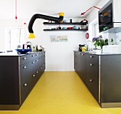 Black furniture and yellow floor in retro kitchen
