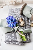 Place setting with cutlery, quail eggs and hyacinths