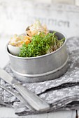 Cress and small snacks in tin