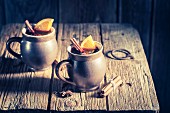 Aromatic mulled wine with cinnamon and star anise on a rustic wooden table