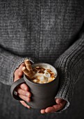 White hot chocolate with marshmallows, caramel sauce and wafer rolls