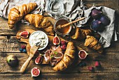 Breakfast with freshly baked croissants, ricotta cheese, figs, fresh berries, prosciutto di Parma and honey