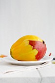 A peeled mango on a plate