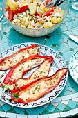 Grilled red peppers filled with sheep's cheese and rosemary, served with potato salad