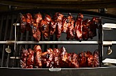 Chunks of pork being grilled on a rotisserie