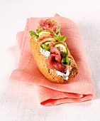 A rye bread roll with tuna and salmon