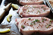Raw pork cutlets seasoned with thyme and coriander