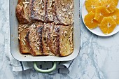 Baked French toast with slivered almonds and orange slices