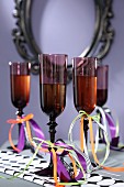 Dark Champagne flutes decorated with ribbons for Halloween