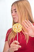 Girl with lolly pop,holding hand out