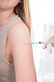 Girl having injection in arm