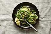 Spaghetti with green asparagus, peas and lime