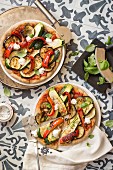 Wholemeal pizzas with grilled vegetables, labneh and basil