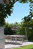 Modern standard lamp above table on sunny terrace