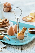 Soft-boiled eggs with toast in an egg rack