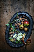 Apples, walnuts, a nutcracker and a knife on a tray