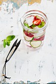 Cucumber and strawberry water with ice cubes
