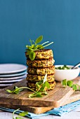 A stack of quinoa veggie fritters on a chopping board