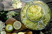 Homemade elderflower syrup with lime in a flip-top glass