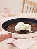 Chocolate cake with vanilla ice cream in a pan