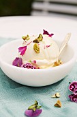 Vanilla and lavender ice cream with pistachios and edible flowers