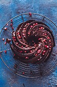 A chocolate Bundt swirl cake garnished with pomegranate seeds